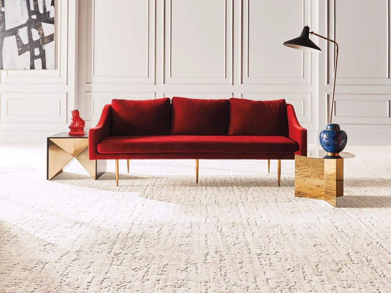 red couch on white nylon carpet